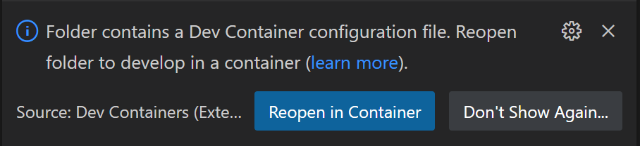 A notification in VS Code saying "Reopen in container"